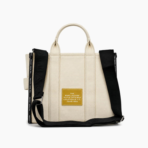 The Tote Bag: Beige avec des détails noirs.