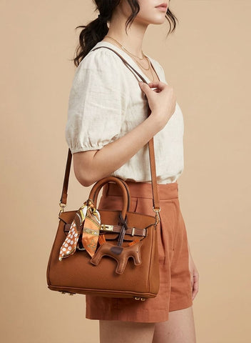 Birkin d'Hermès Cuir camel et accessoires orange