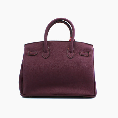 Birkin d'Hermès Cuir bordeaux et accessoires rouge et jaune.